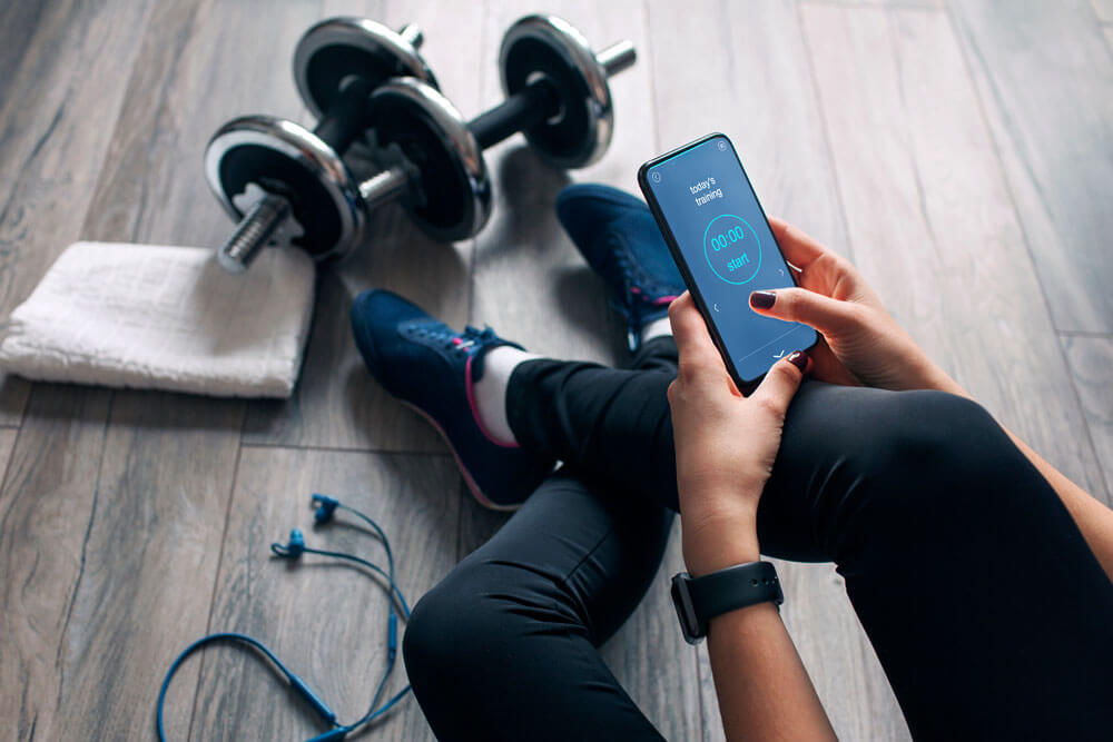 Person holding a smart phone after exercising.
