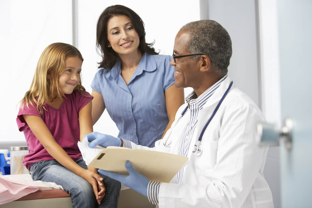 Doctor and child patient with her mom
